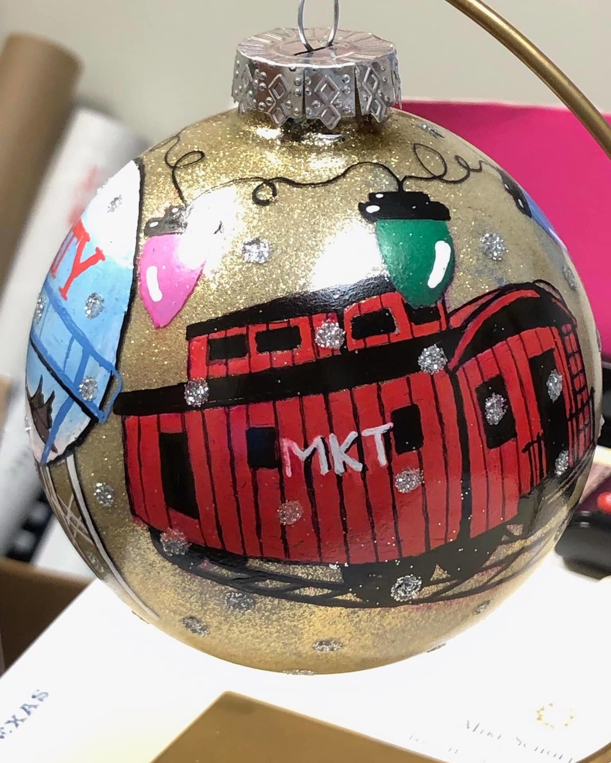 The ornament features an image of the iconic Katy caboose